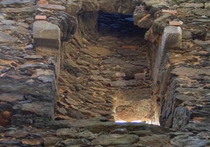 Detail of the cantilevered hearth with chimney and an outlet to a defunct tiled stove.